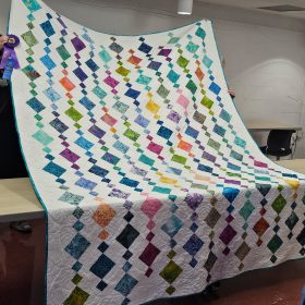 The Tropical Dreams raffle quilt, grand champion at the montgomery county fair a beaded waterfall design in tropical colors